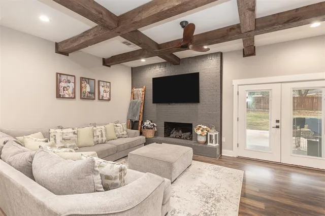 a living room with furniture a fireplace and a flat screen tv