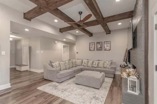 a living room with furniture and a wooden floor