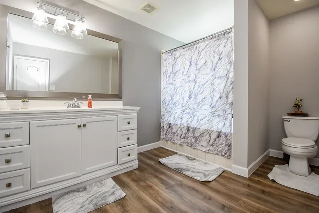 a spacious bathroom with double vanity sink and a mirror