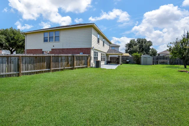 a view of a house with a yard and sitting area