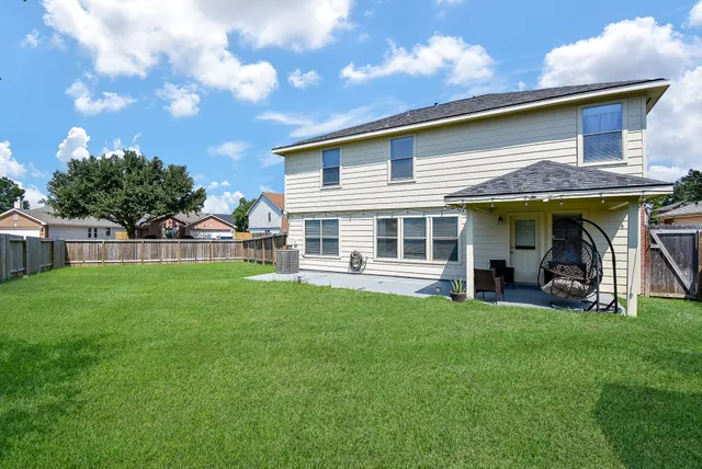a view of a house with a yard and sitting area