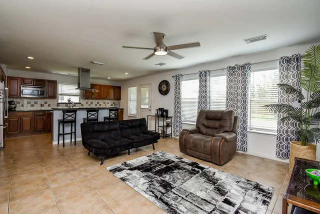 a living room with furniture and a dining table