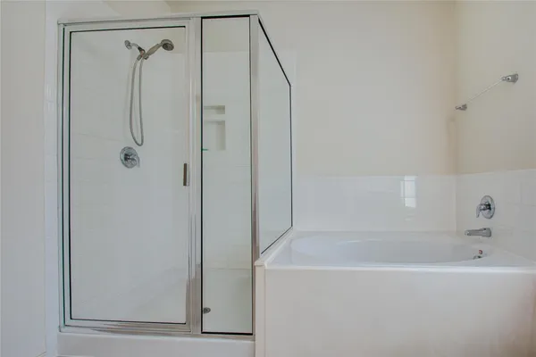a bathroom with a shower and a bath tub