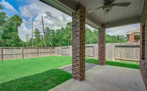 a backyard of a house with plants and wooden fence