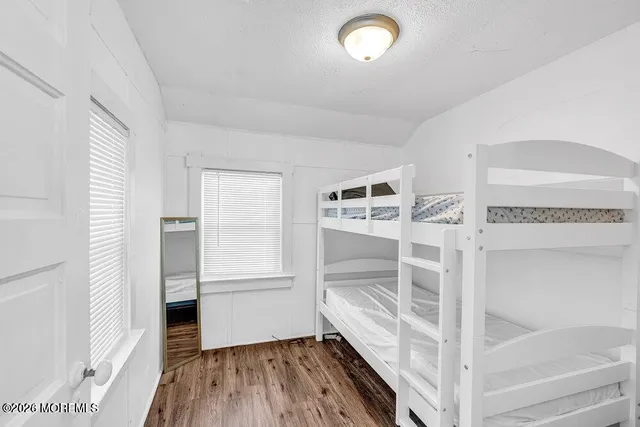 a view of a room with wooden floor and white walls
