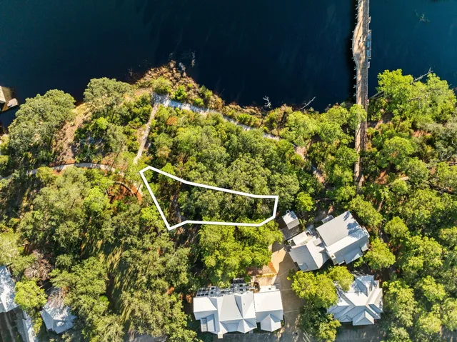 a backyard of a house with lots of green space and a fountain