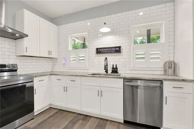 a kitchen with white cabinets and a sink