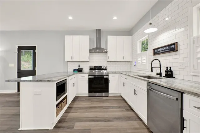 a kitchen with granite countertop white cabinets and white appliances
