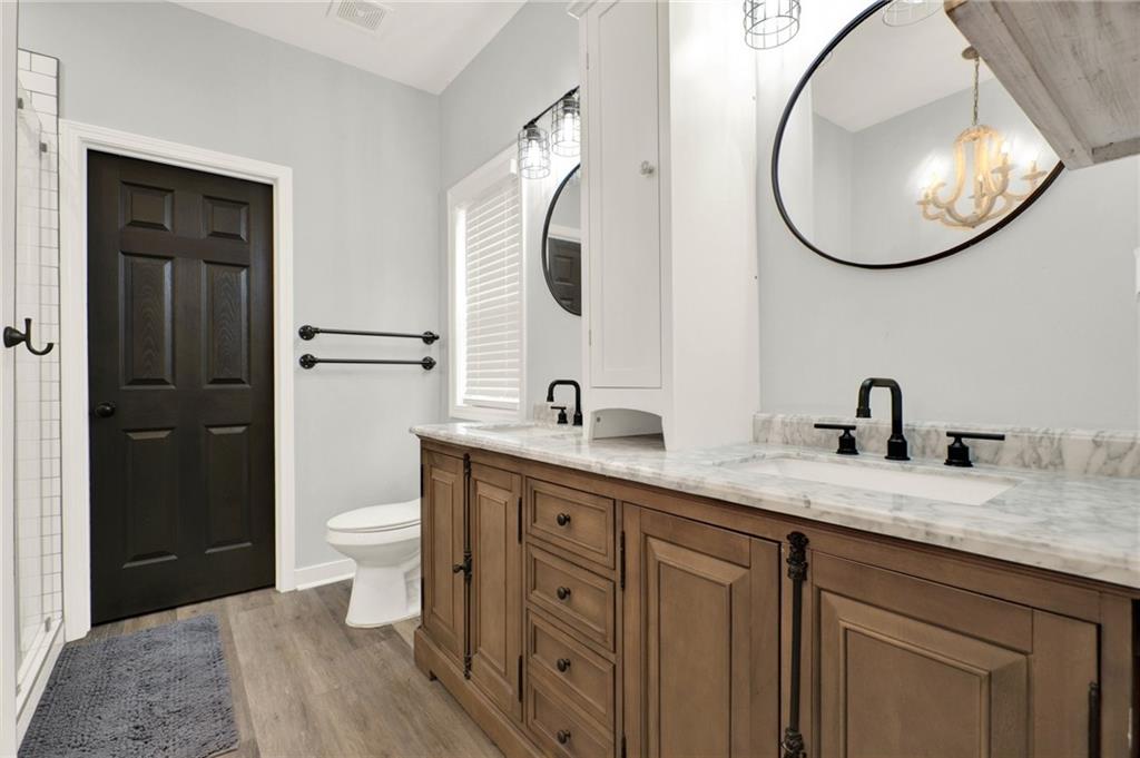 92 Autumn Path Rockmart, GA 30153 - Photo 21 of 44 a spacious bathroom with a granite countertop toilet sink and mirror