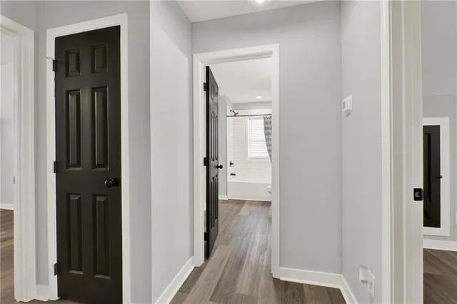 a view of a hallway with wooden floor