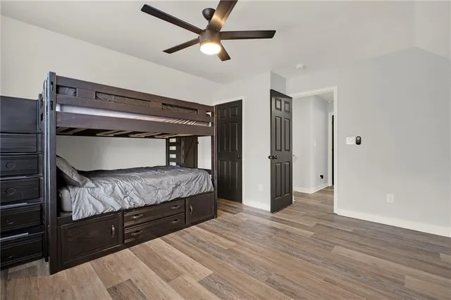 a bedroom with a bed and a ceiling fan