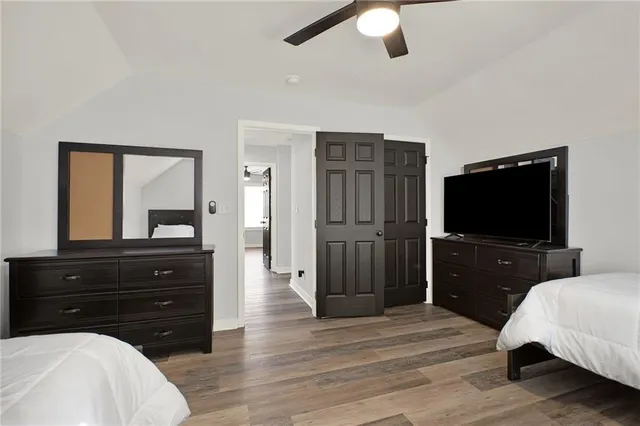 a living room with a bed and a flat screen tv