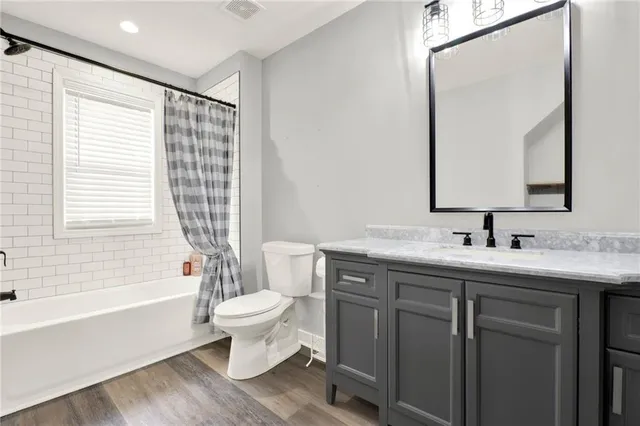 a bathroom with a double vanity sink toilet and shower