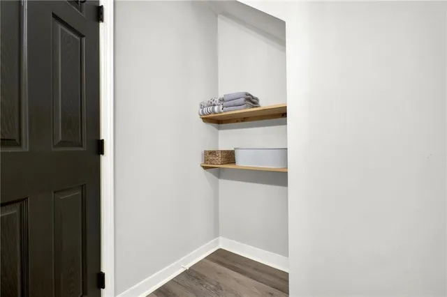 a view of a house with a yard and large tree