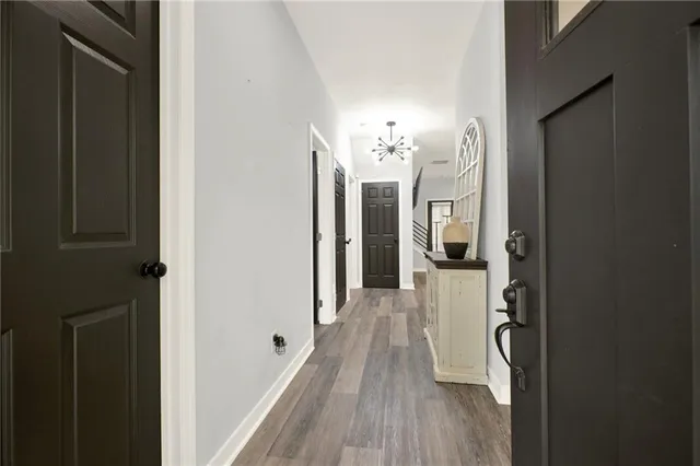 a view of a hallway with wooden floor