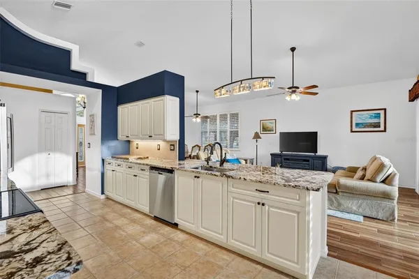 a kitchen with stainless steel appliances granite countertop a stove a sink and a refrigerator