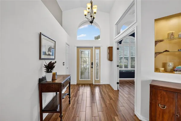 a hallway with furniture and wooden floor