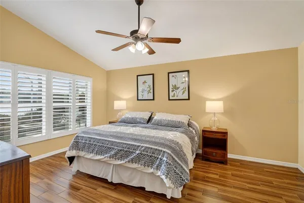 a bedroom with a bed and wooden floor
