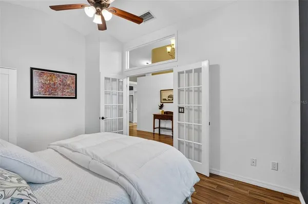 a bedroom with a bed and a window