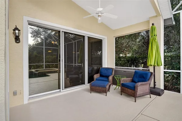 a view of a swimming pool with a patio and a yard