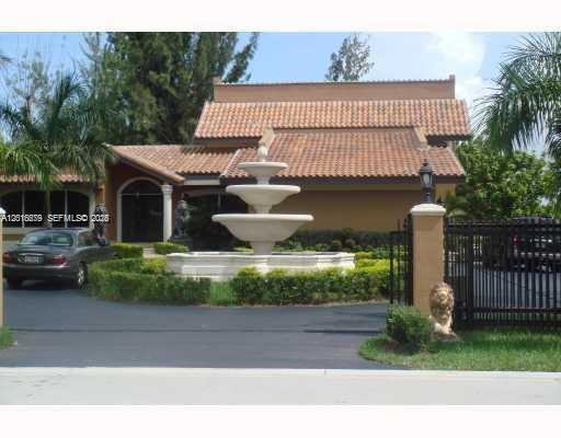 12425 Southwest 43rd Street Miami, FL 33175 - Photo 1 of 11 a front view of a house with a garden and plants