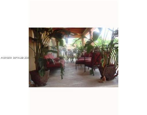 12425 Southwest 43rd Street Miami, FL 33175 - Photo 8 of 11 a living room with furniture and a potted plant