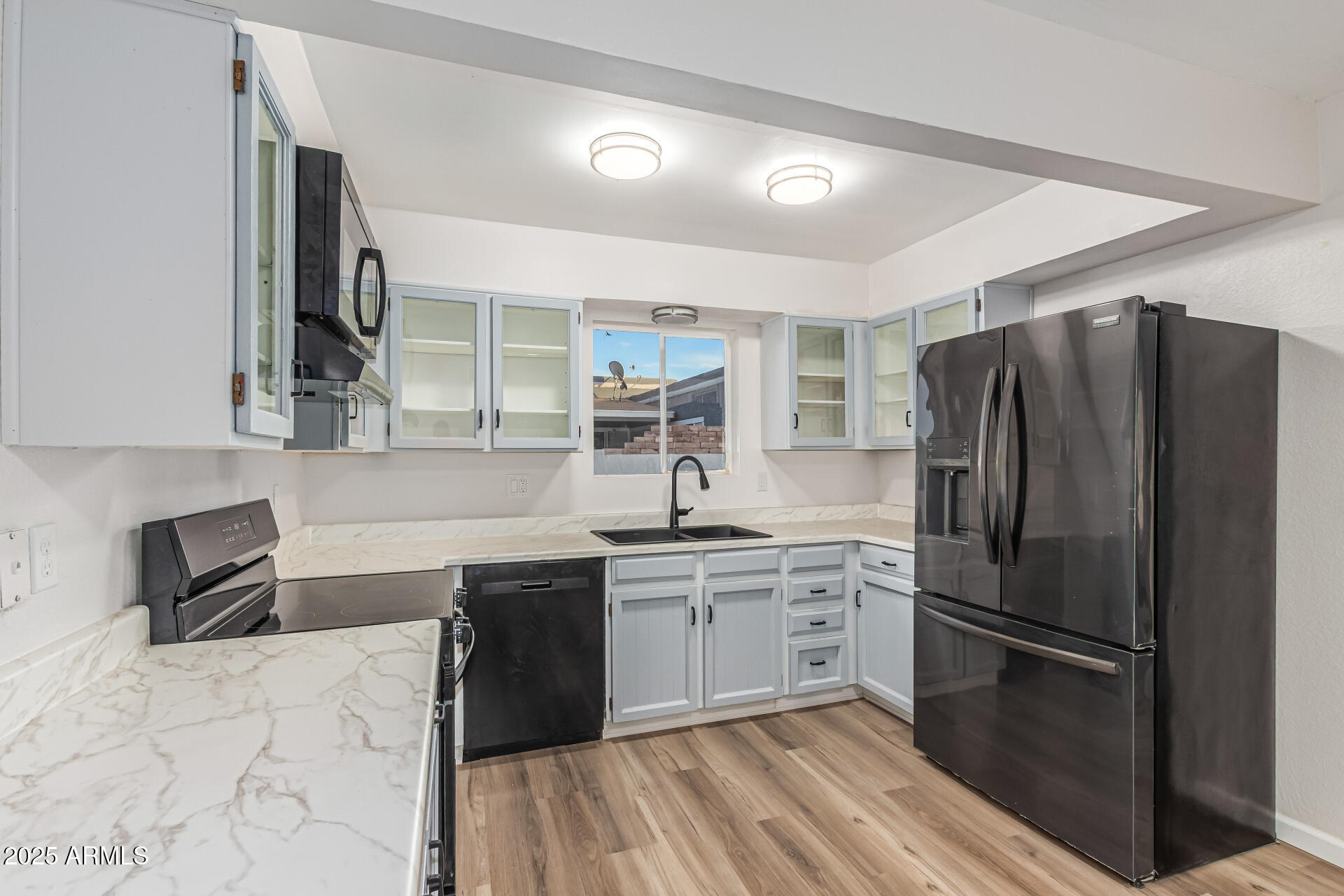1232 East McLellan Road Mesa, AZ 85203 - Photo 12 of 31 a kitchen with a sink stainless steel appliances and cabinets