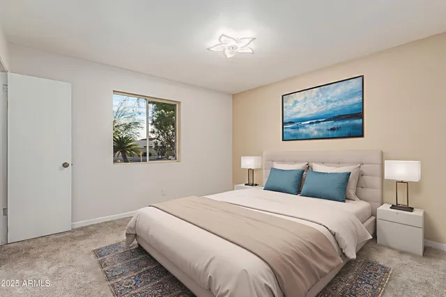 a bedroom with a bed and a painting on the wall