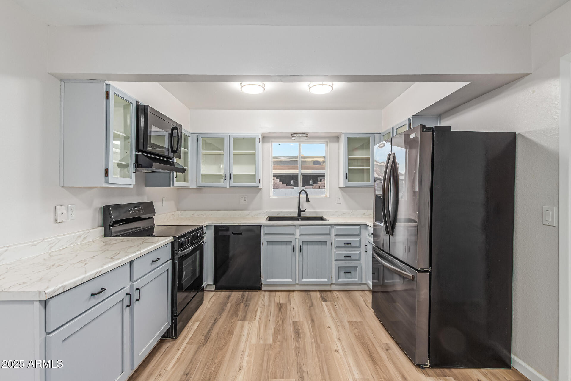 1232 East McLellan Road Mesa, AZ 85203 - Photo 13 of 31 a kitchen with a refrigerator stove and sink
