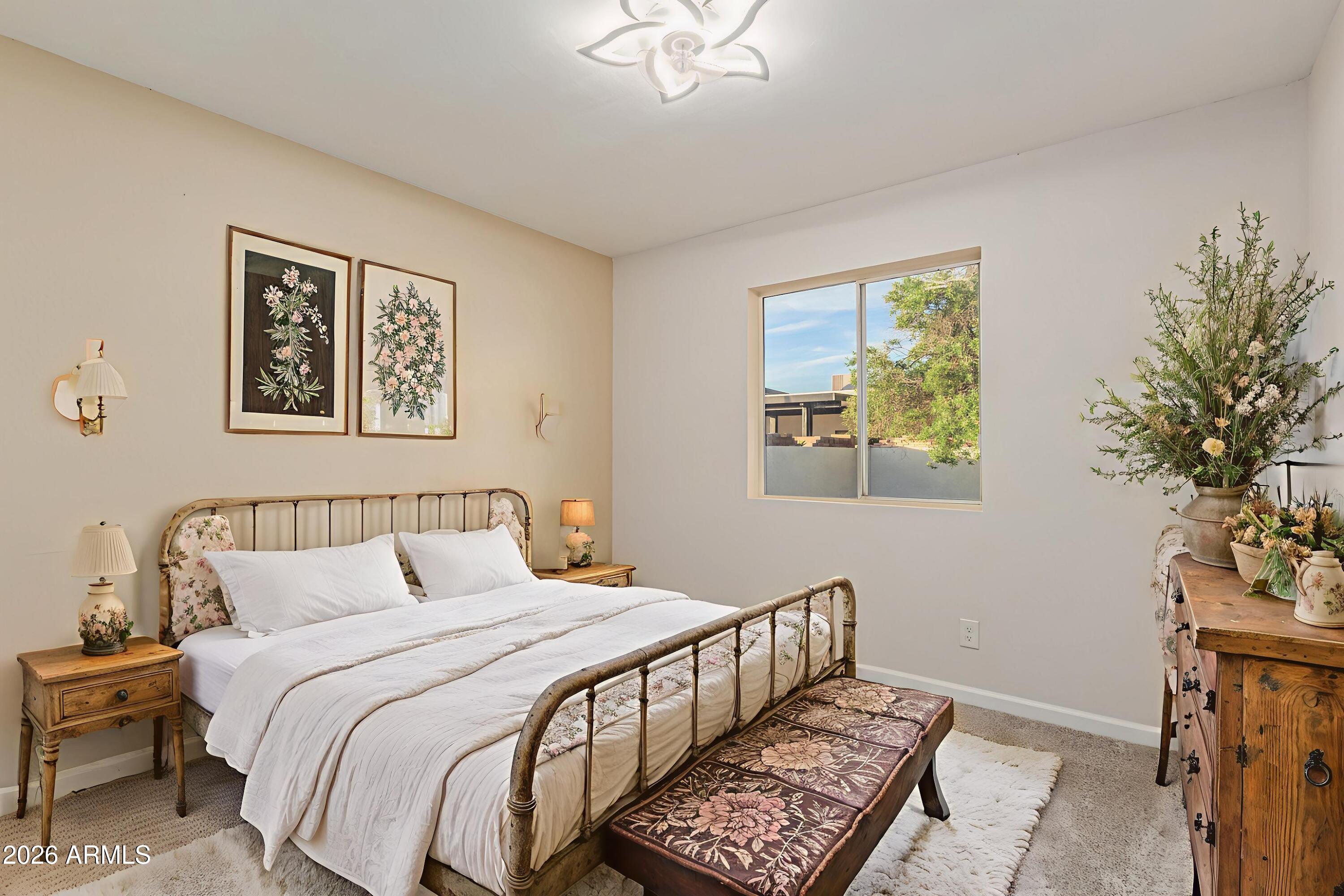 1232 East McLellan Road Mesa, AZ 85203 - Photo 20 of 31 a bedroom with a bed and a chandelier