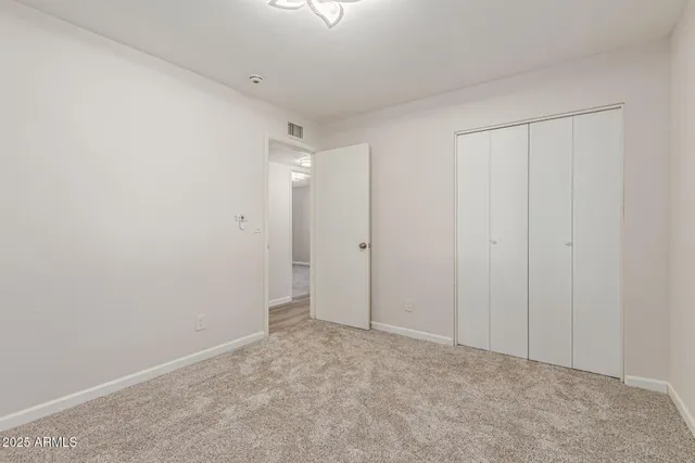 a bathroom with a granite countertop sink a toilet and a mirror
