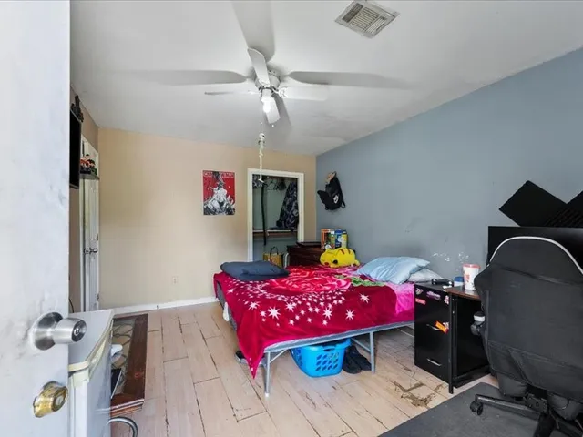 a view of a bedroom with a bed and a window