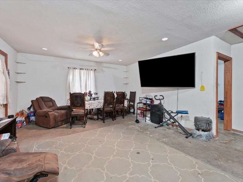 1418 South 7th Street Conroe, TX 77301 - Photo 18 of 36 a living room with furniture and a flat screen tv