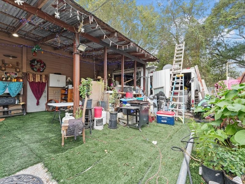 1418 South 7th Street Conroe, TX 77301 - Photo 23 of 36 a view of a chairs and tables in patio with a table and chairs