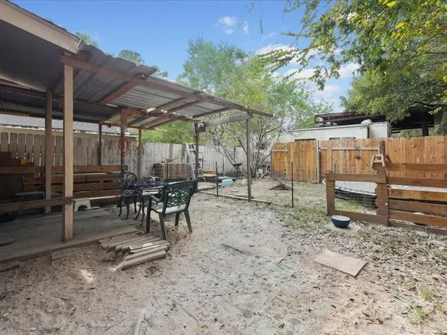 a backyard of a house with a yard and outdoor seating
