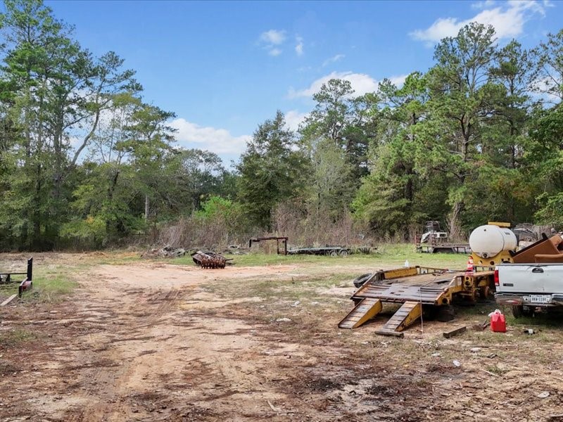 1418 South 7th Street Conroe, TX 77301 - Photo 26 of 36 a view of backyard of a house with seating space
