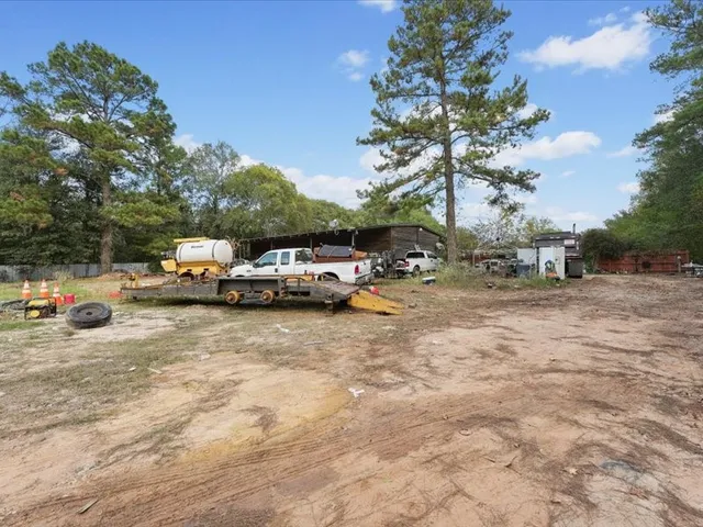 a view of an house with backyard space and balcony
