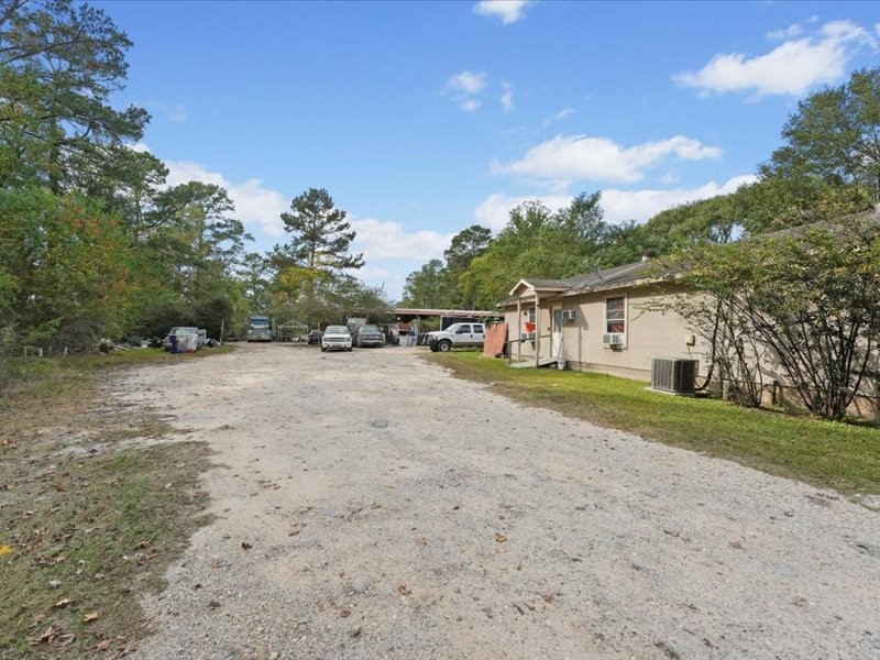 1418 South 7th Street Conroe, TX 77301 - Photo 30 of 36 a view of an house with backyard space and balcony