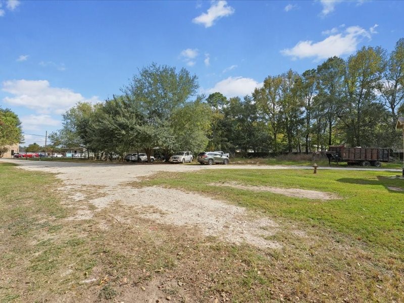 1418 South 7th Street Conroe, TX 77301 - Photo 33 of 36 a view of outdoor space with swimming pool and green space