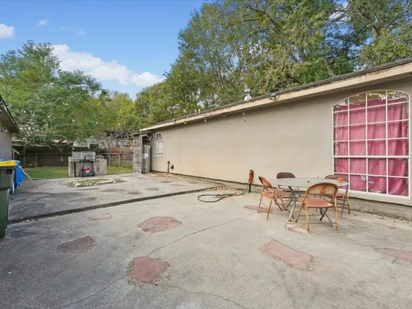 a backyard of a house with table and chairs