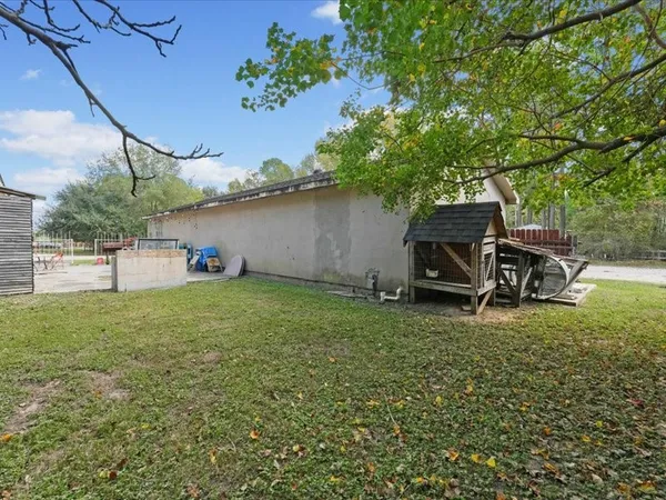 a backyard of a house with table and chairs