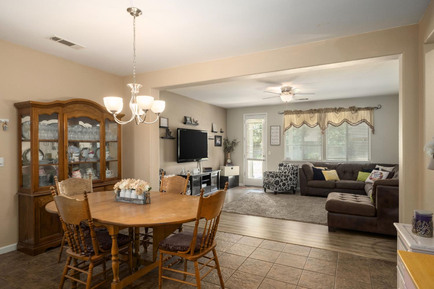 454 Sierra Avenue Reedley, CA 93654 - Photo 8 of 25 a living room with furniture a flat screen tv and a large window