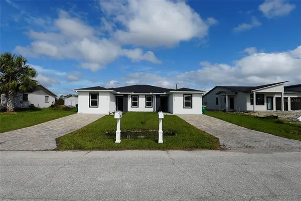 a front view of house with yard and green space