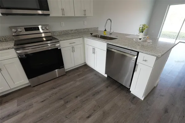 a kitchen with a sink and cabinets