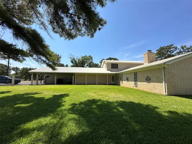 a front view of house with yard and trees