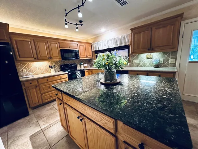 a kitchen with sink stove and cabinets