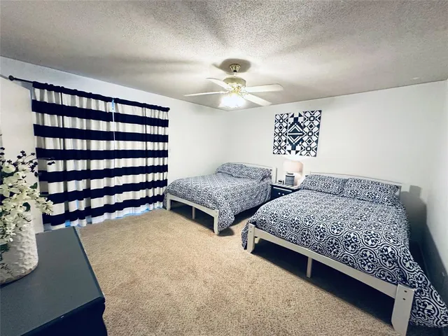 a bedroom with two beds and a chandelier