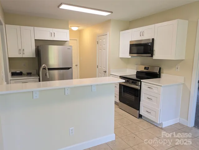 a kitchen with a refrigerator and a sink