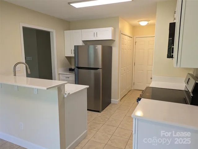 a kitchen with stainless steel appliances granite countertop a sink and a stove
