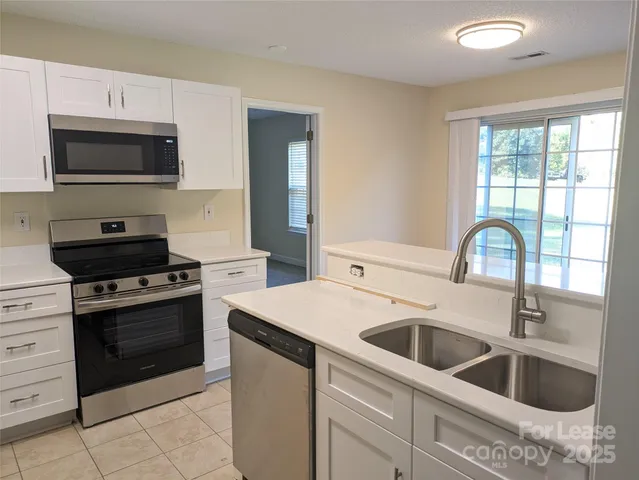 an empty room with sliding door and mountain view
